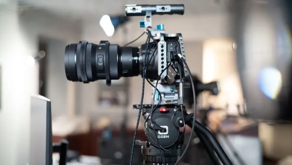 Professional video camera setup on a tripod.