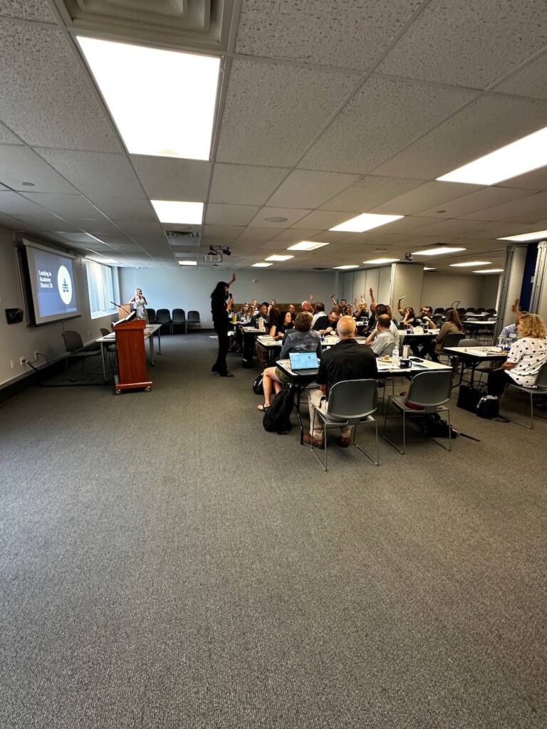 A group of people attending a presentation in a conference room.